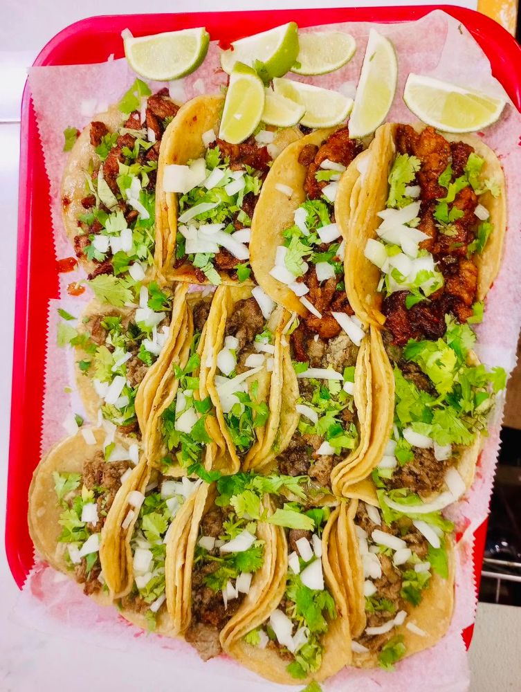 The family taco tray: a red tray of street tacos with cilantro, onion and lime